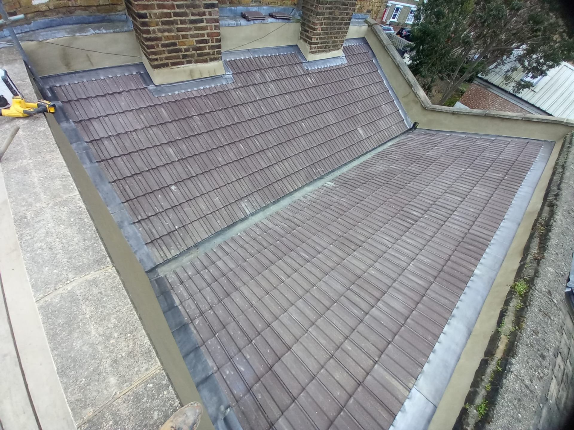 Concrete tile roof with lead flashing around chimneys