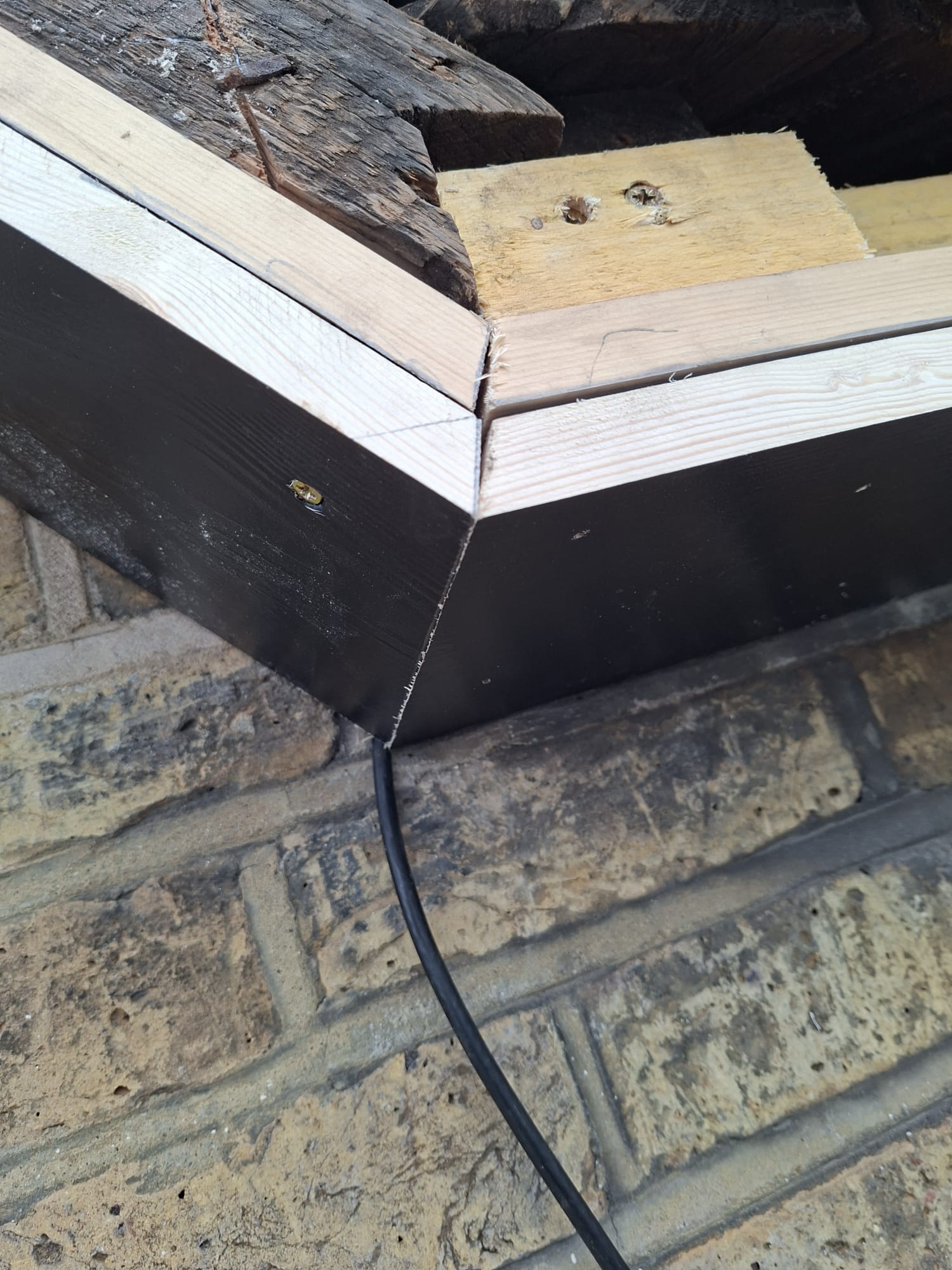 Fascia board corner repair with new timber and black cladding