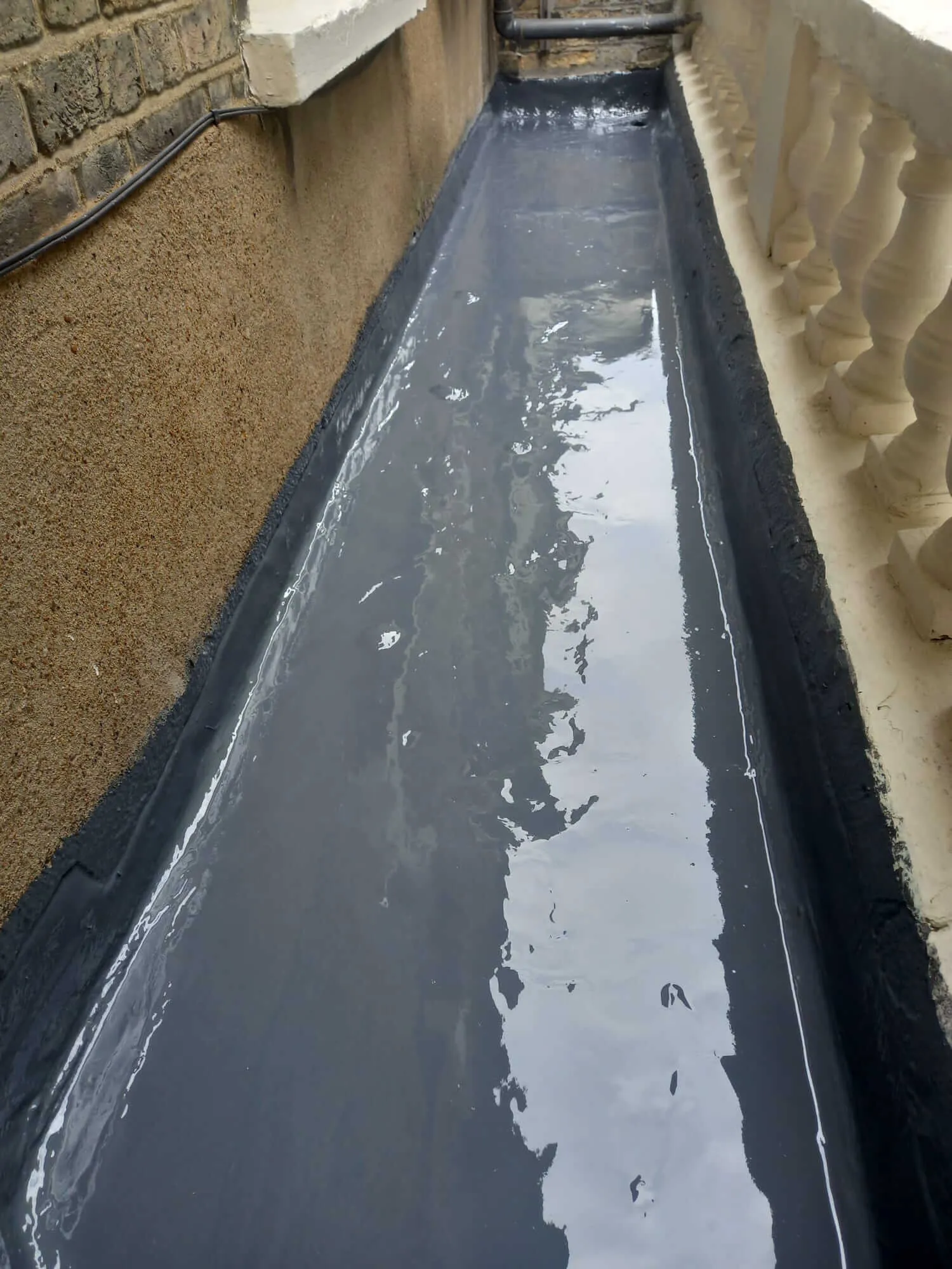 Flat roof gutter channel waterproofing with liquid applied membrane