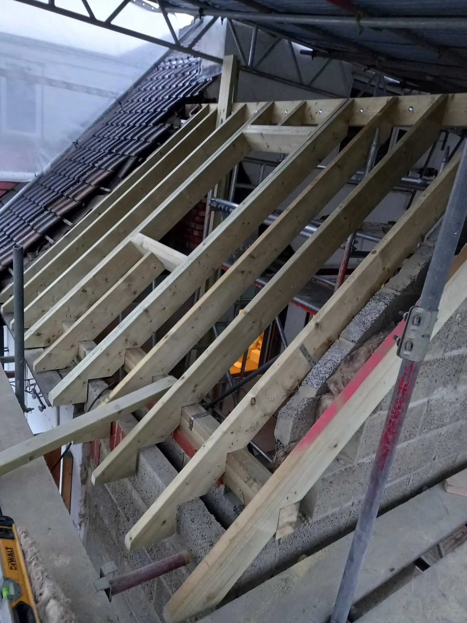 Loft conversion interior timber framing with exposed brickwork