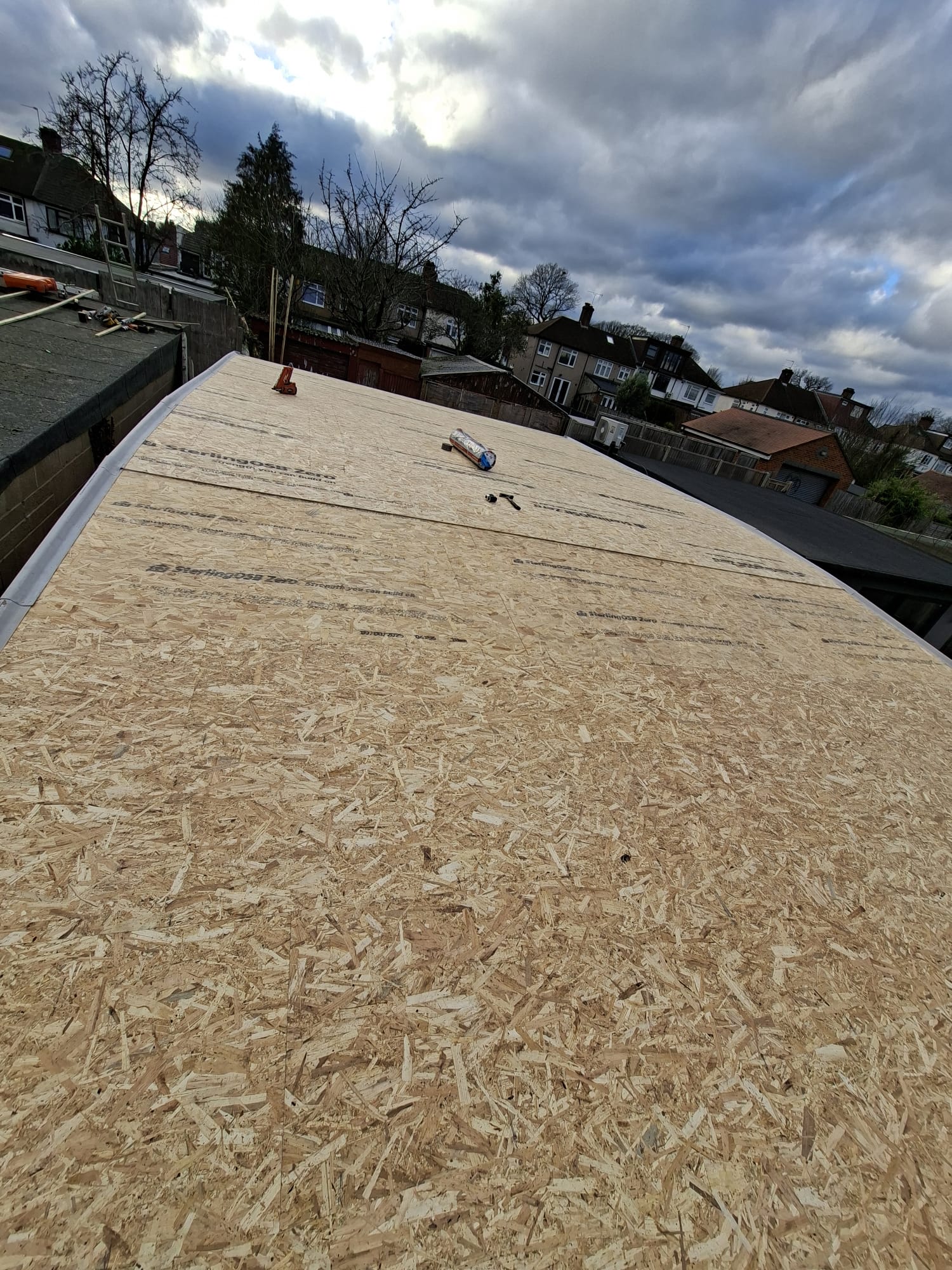 OSB board decking prepared for felt roofing on extension