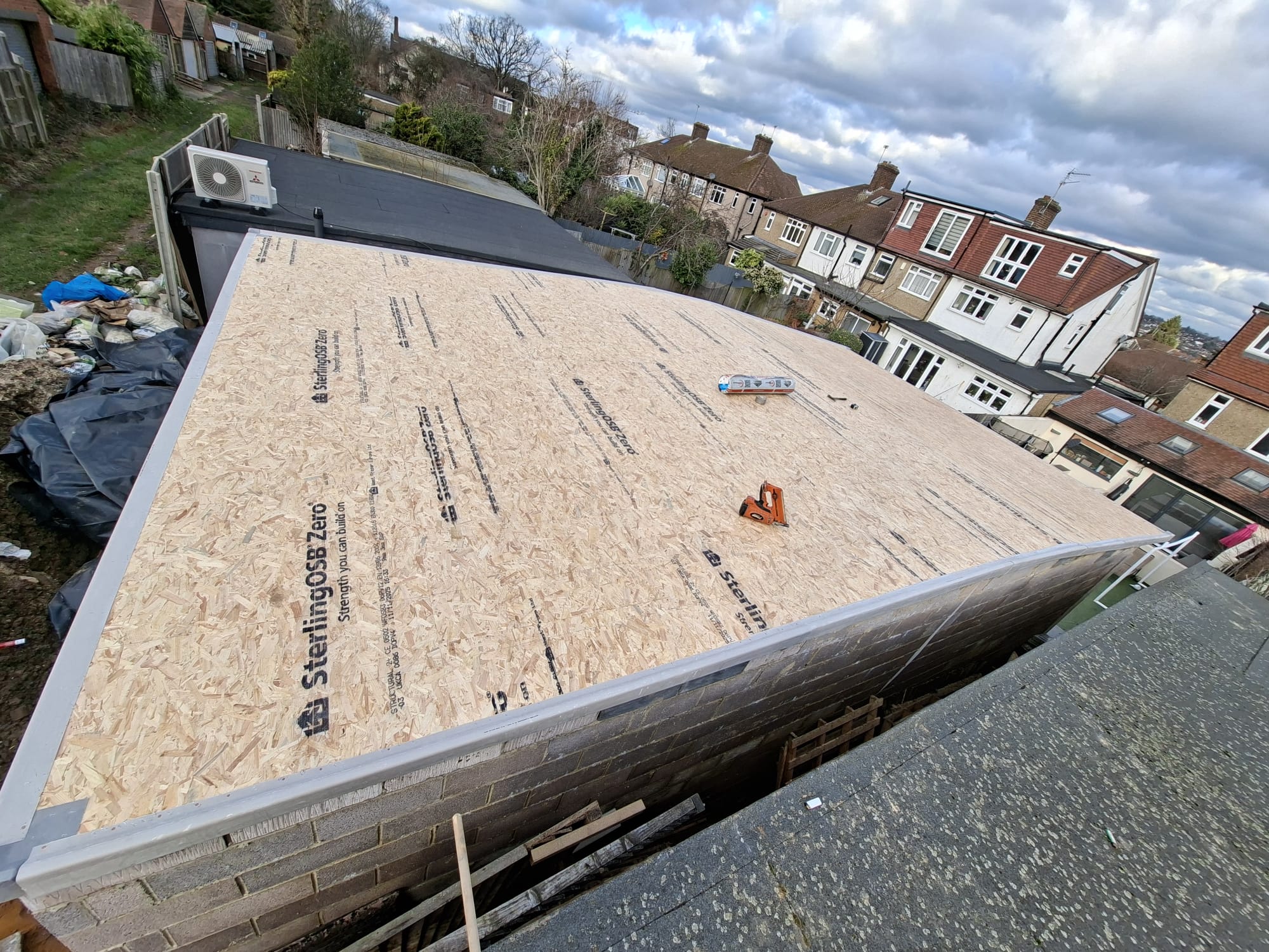 Wide OSB board flat roof deck ready for felt roofing