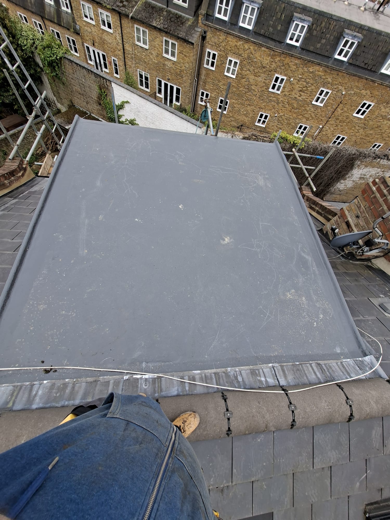 Rubber flat roof surrounded by slate tiles on Victorian property