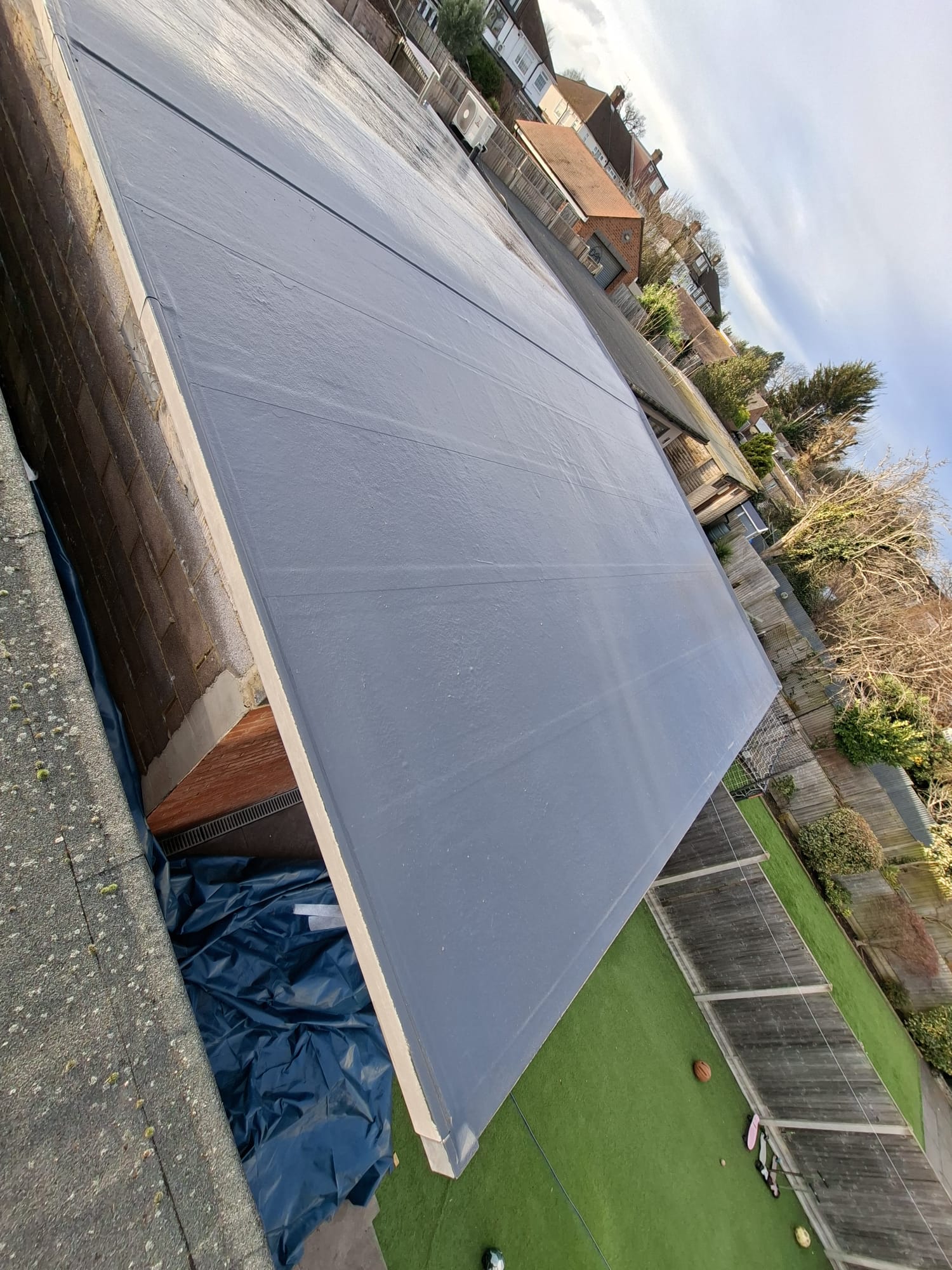 EPDM rubber roof on garage extension with garden view