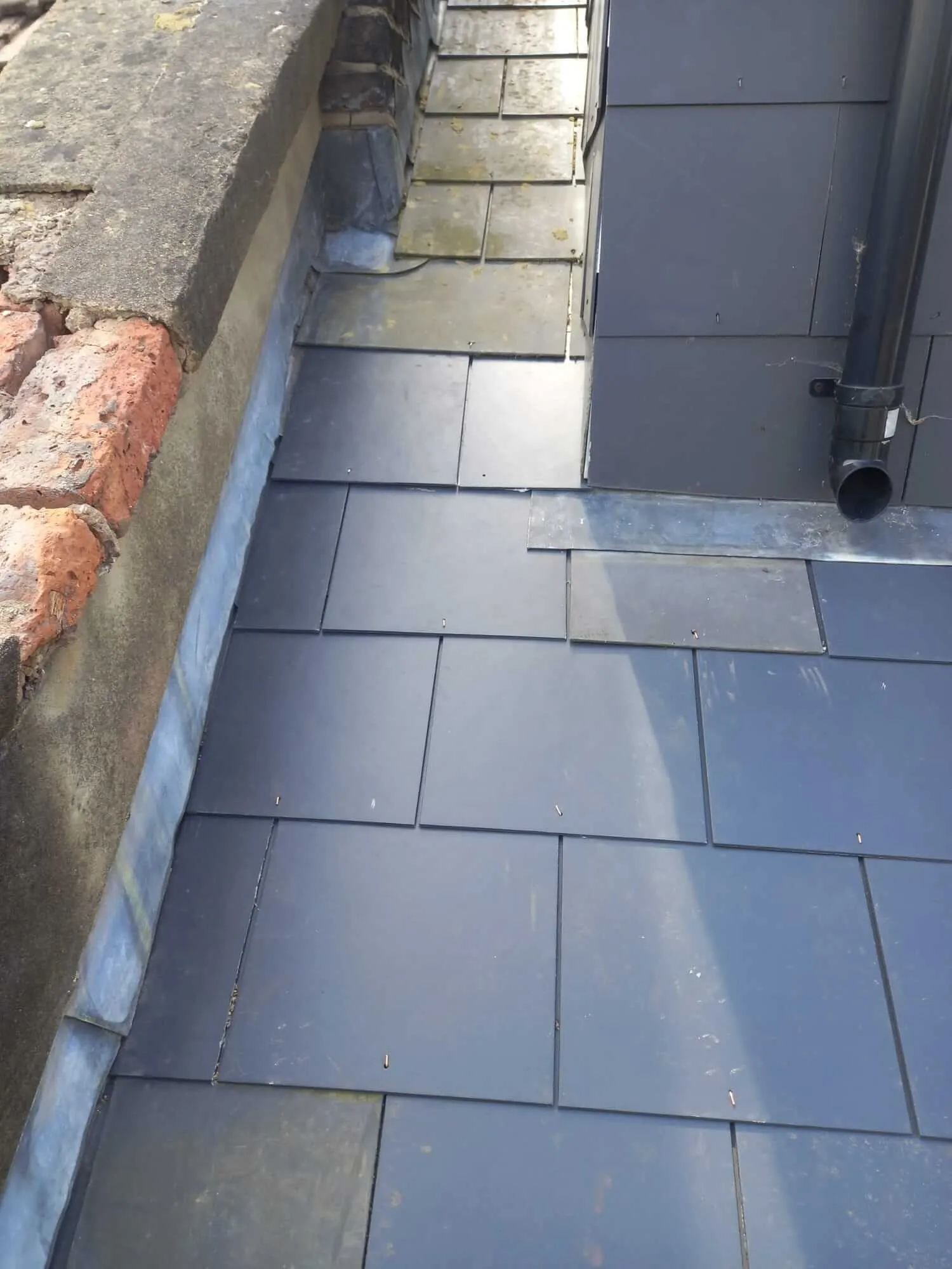 New slate tiles around dormer with lead flashing detail on North London property
