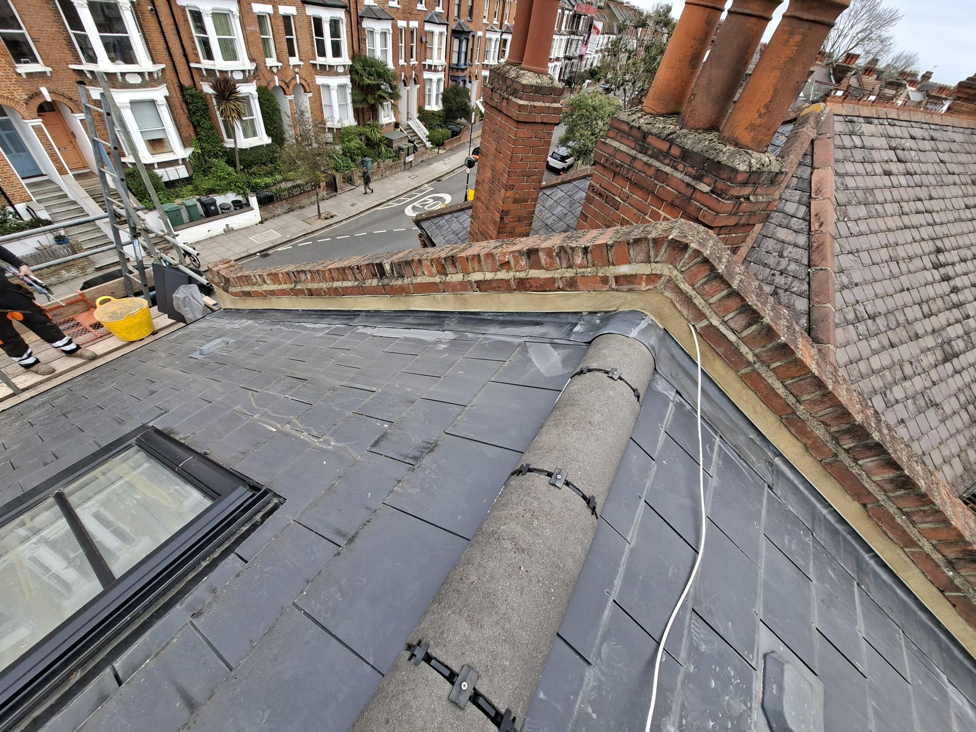 New slate roof with ridge tiles and chimney on London terraced house