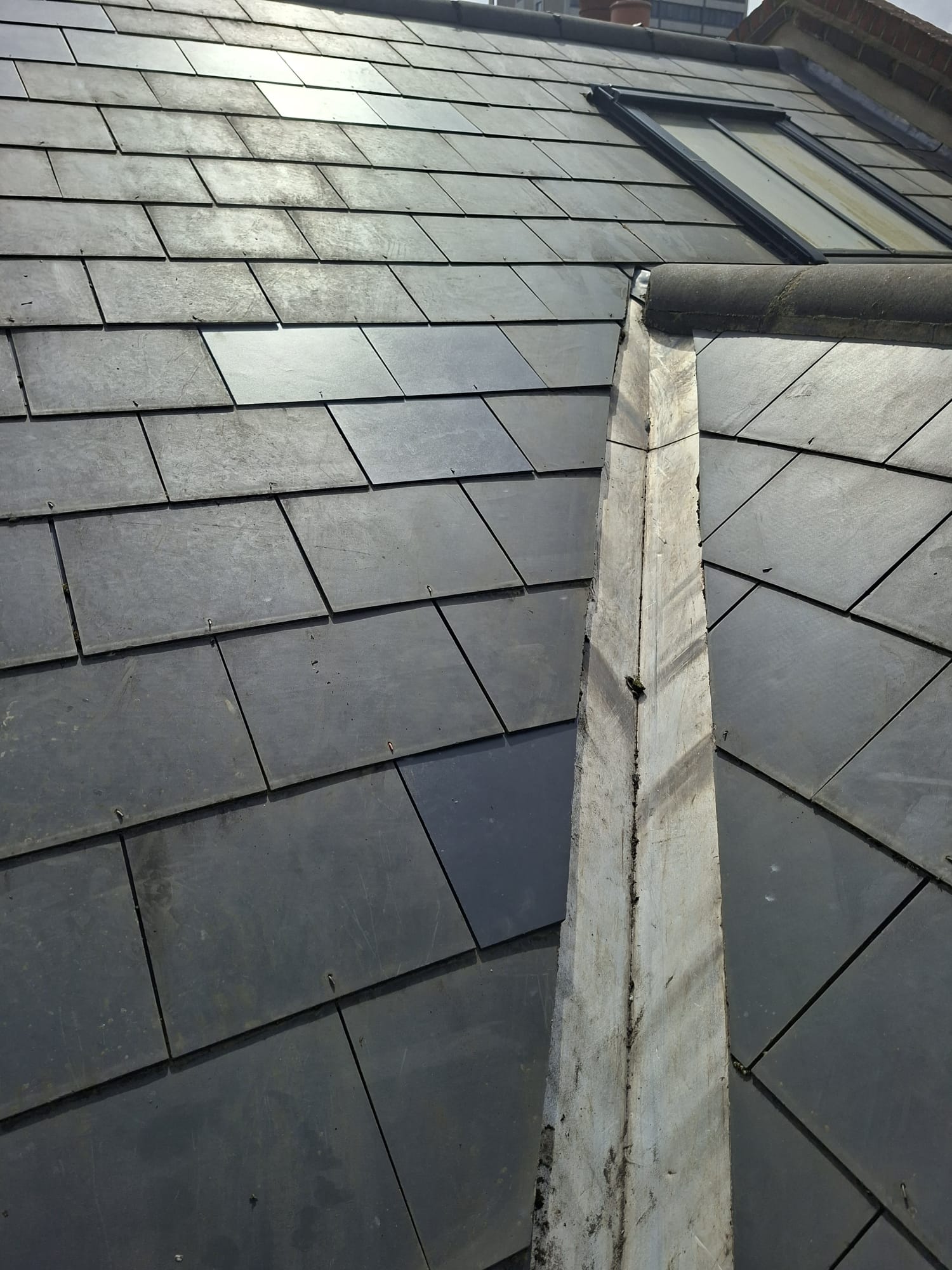 Close-up of slate roof ridge tile mortar detail