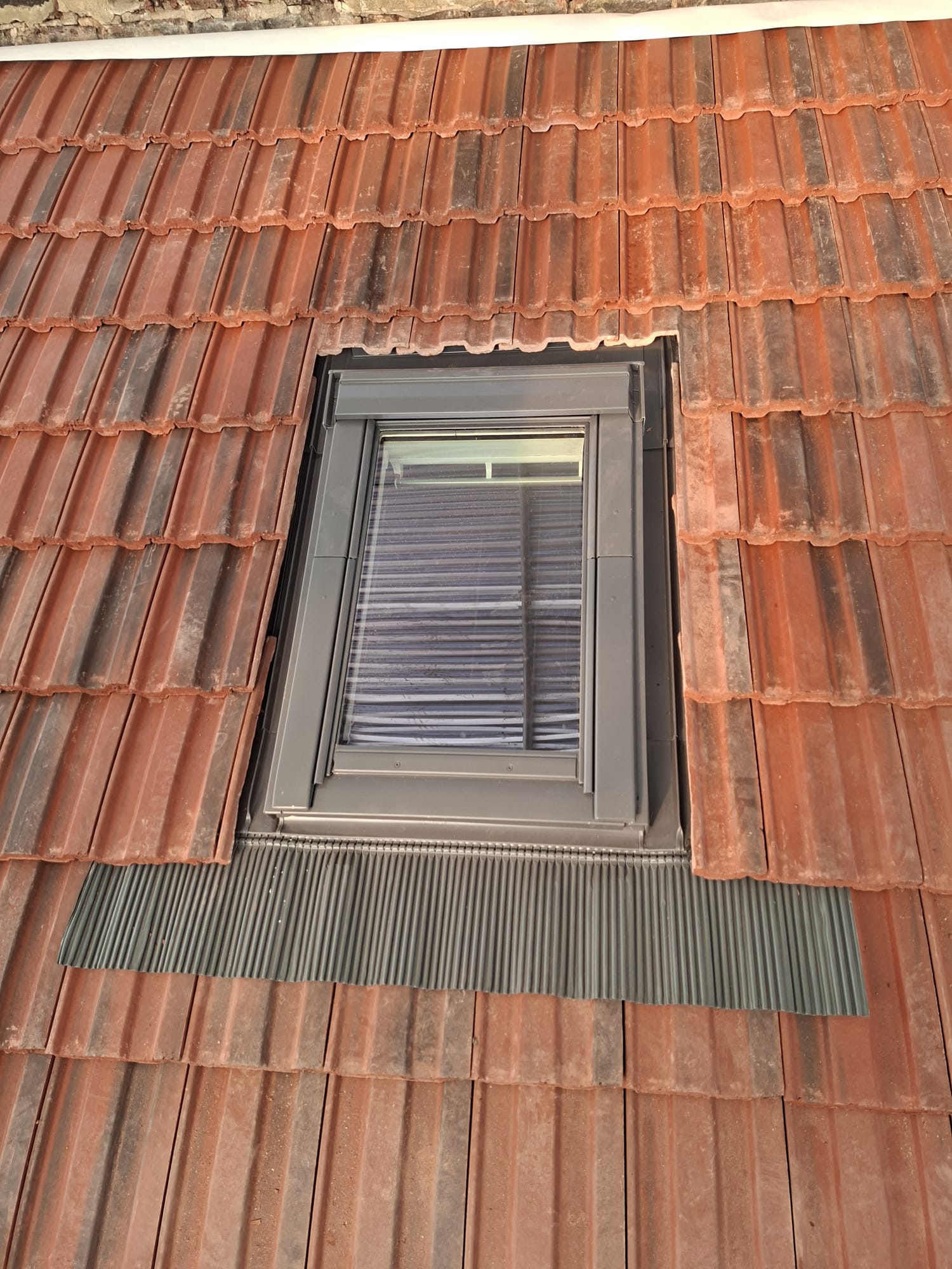 Velux window installed in new clay tile roof